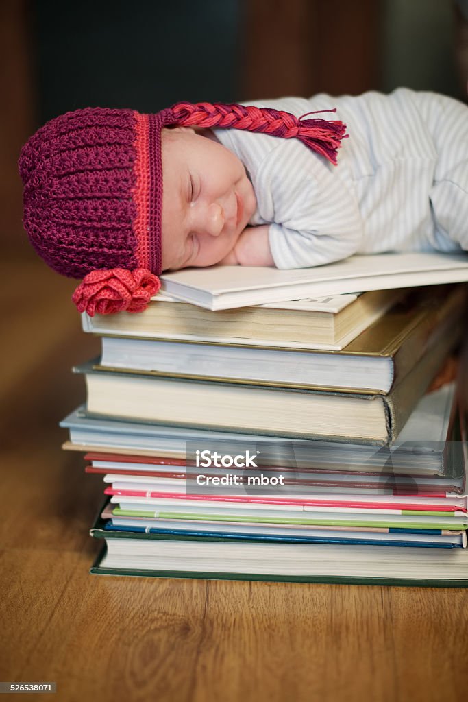 baby sleeping on stack of books cute baby sleeping on stack of books Baby - Human Age Stock Photo