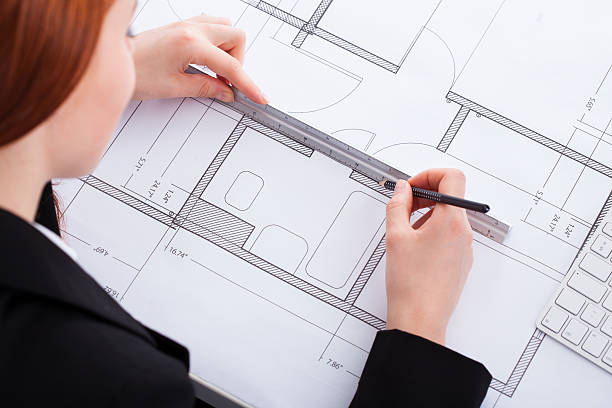 istock Businesswoman Working On Blueprint 526538445
