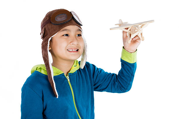 istock Asian Chinese Boy Playing with Wooden Airplane 526543158