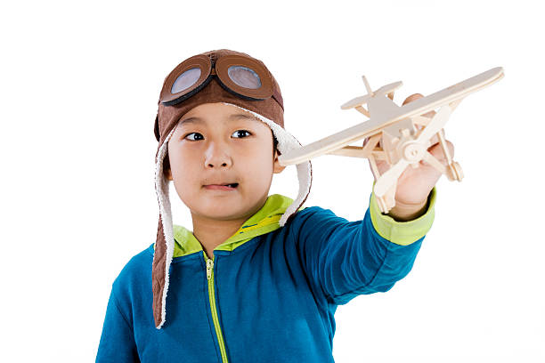 istock Asian Chinese Boy Playing with Wooden Airplane 526543202