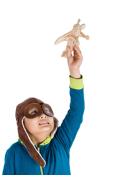 istock Asian Chinese Boy Playing with Wooden Airplane 526543228