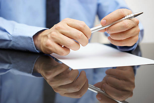 istock closeup of business man reading document or contract 526544305
