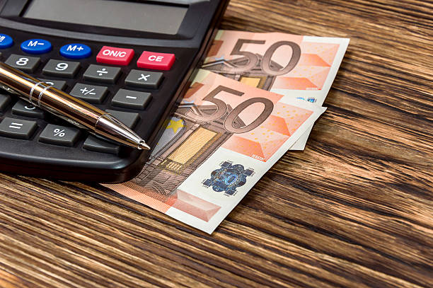 istock Calculator, pen and euro on wooden table 526545802