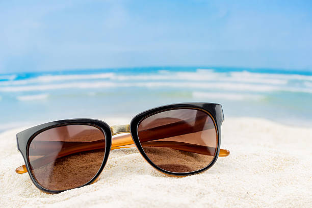istock sunglasses in the sand at the beach 526548492