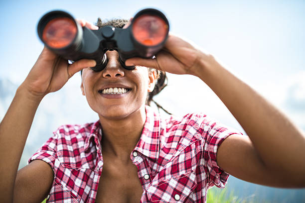 istock woman with binocular on top of mountain 526548634