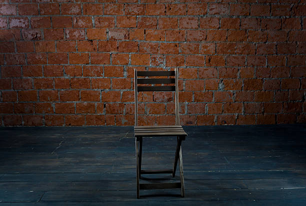 istock Chair and old brick wall 526550393