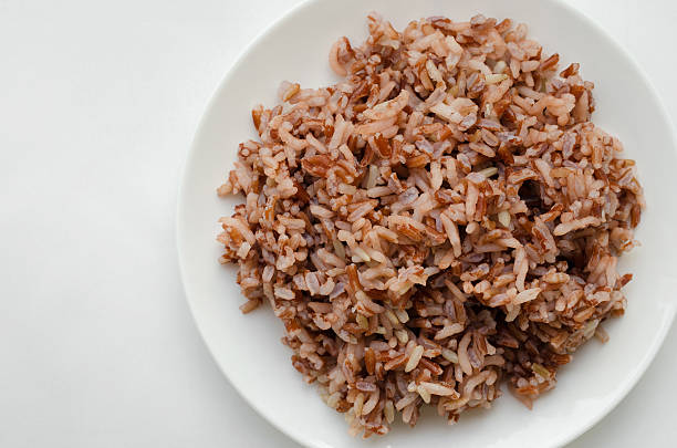 istock Brown Rice In The White Plate On White Background. 526550624