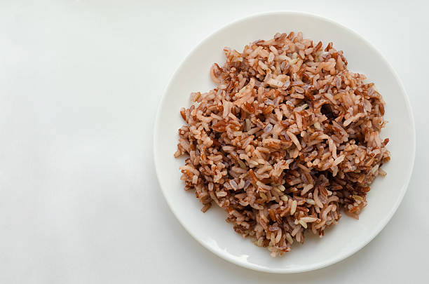 istock Brown Rice In White Plate On White Background. 526550808