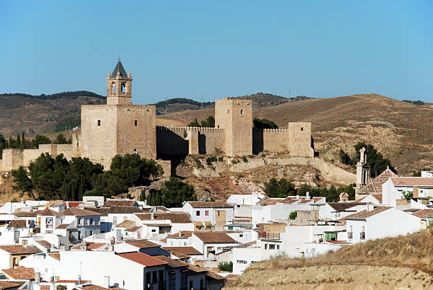 Antequera, Spain - July 1, 2008: View of the castle fortress with townhouses in the foreground, Antequera, Malaga Province, Andalucia, Spain, Western Europe.
