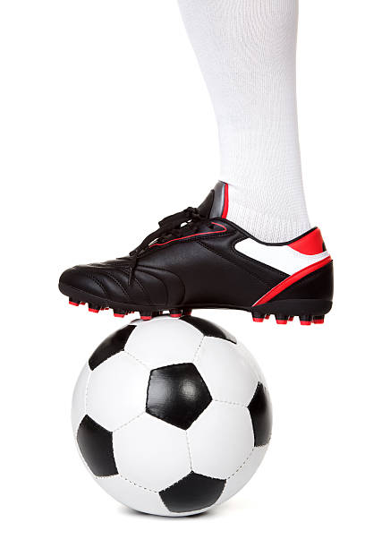 Football player with ball on white Leg of soccer player with ball on white background football boot stock pictures, royalty-free photos & images