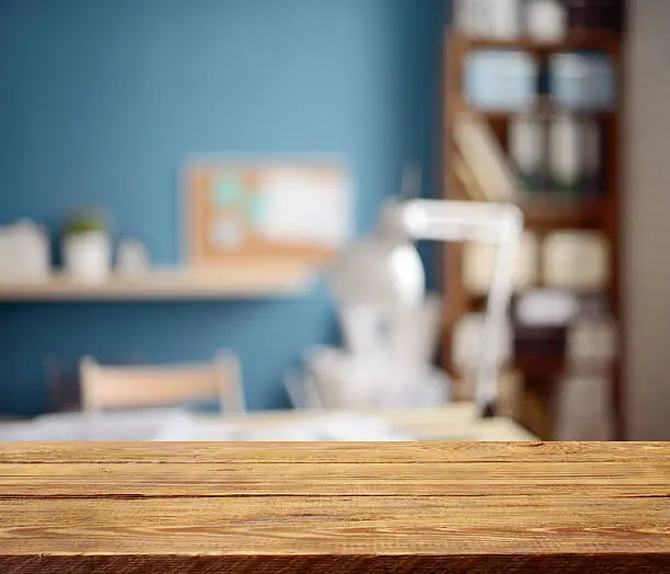 Defocused empty office interior and a wooden background