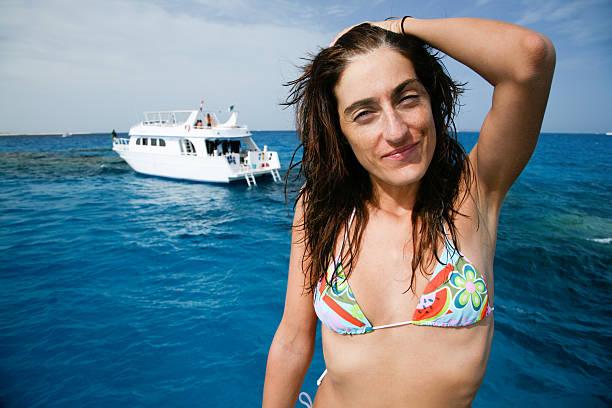 istock bikini woman on boat looking 526552396