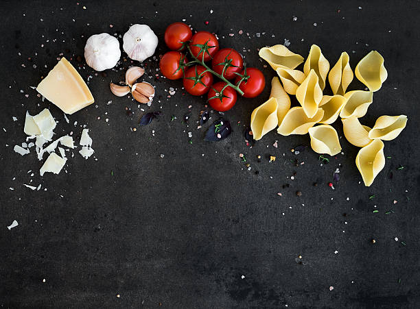 istock Food frame. Pasta ingredients on dark grunge backdrop, copy space 526552418