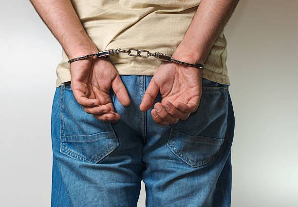 istock Adult male arrested and handcuffed 526556298