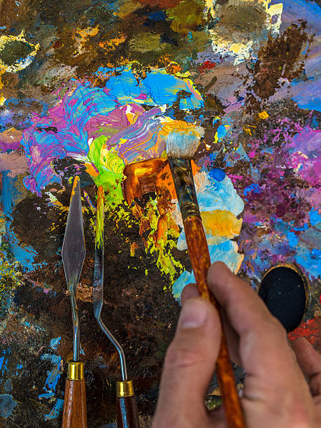 istock Hand of artist with a paintbrush 526556466