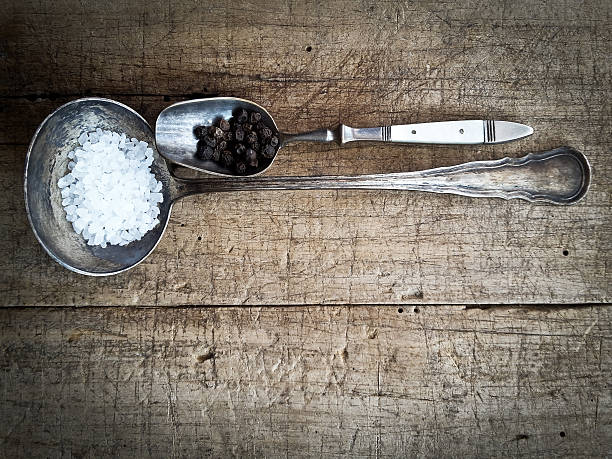 istock salt and pepper on an old spoon 526558842