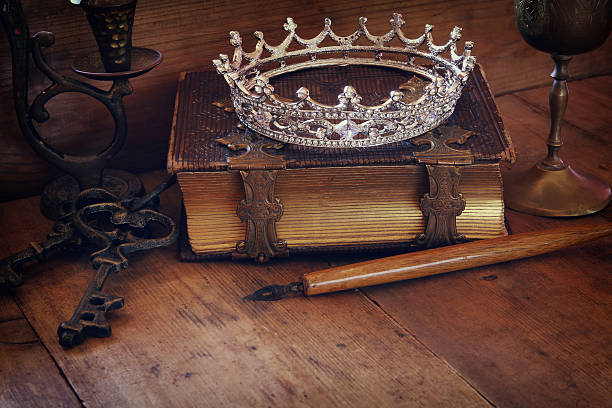 istock low key image of diamond queen crown on old book 526559854
