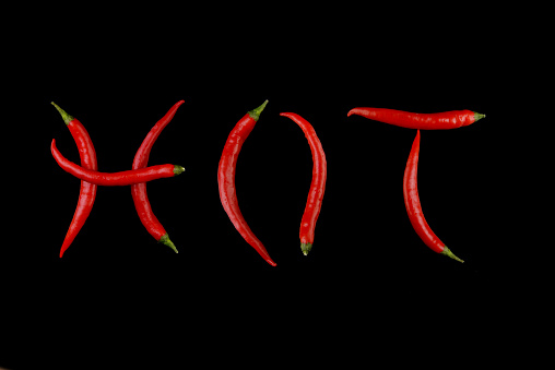 Red chili pepper on black background