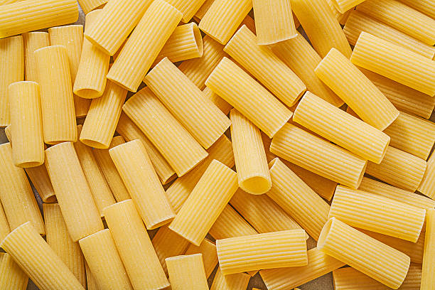 istock Short-cut raw pasta background food and drink concept 526563274