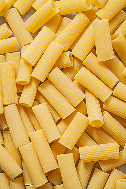 istock Short-cut uncooked pasta backdrop food and drink concept 526563332