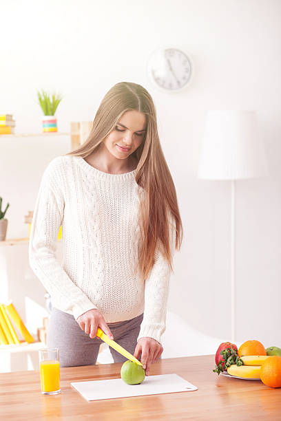 istock Beautiful young pregnant woman is preparing breakfast 526564574