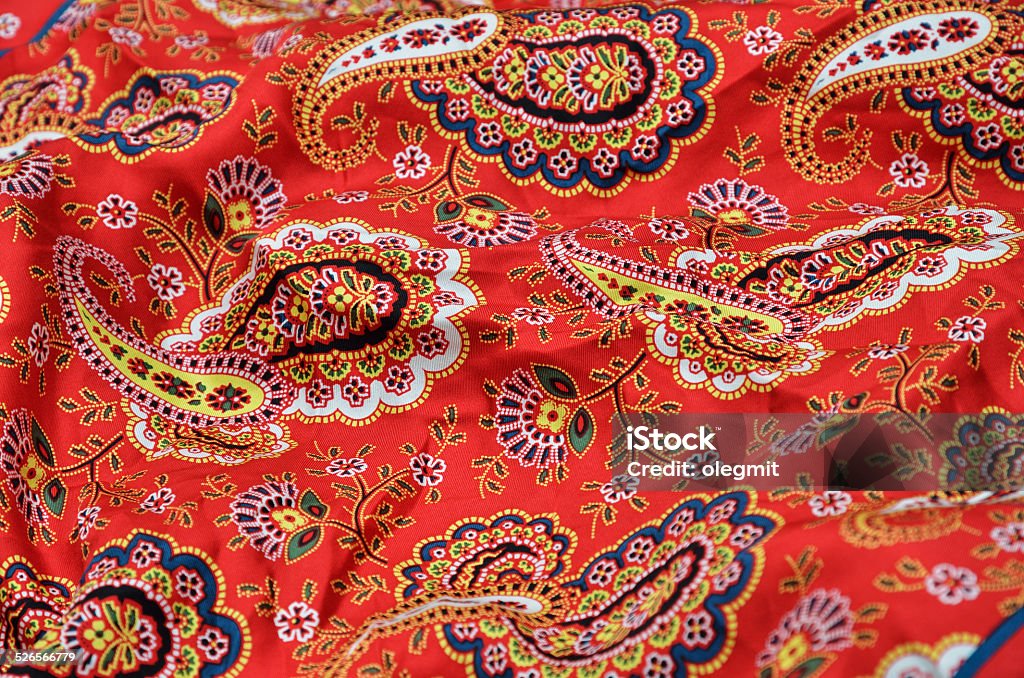 Background of the Paisley shawl The red cloth with Welsh pears is photographed close-up. Backgrounds Stock Photo
