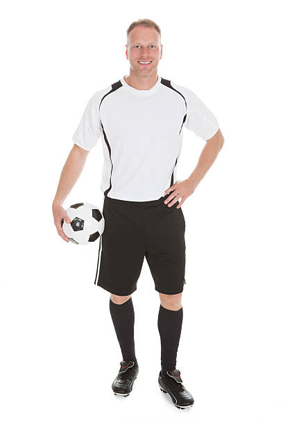istock Soccer Player Holding Football 526567075