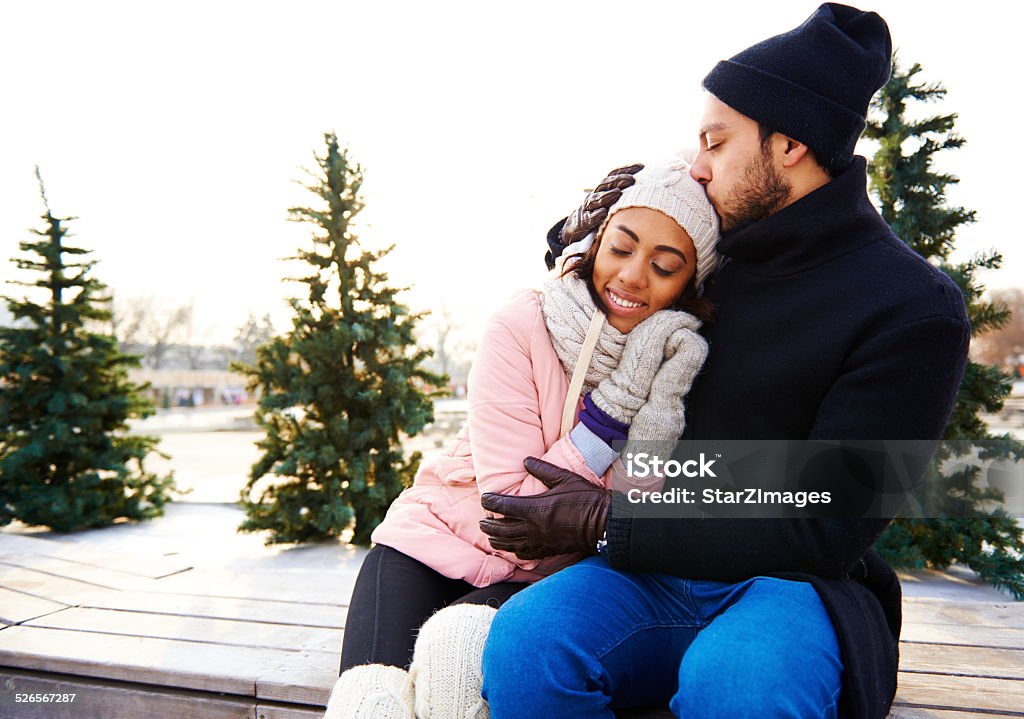 Warming together Ice skating couple having winter fun on ice skates 20-24 Years Stock Photo