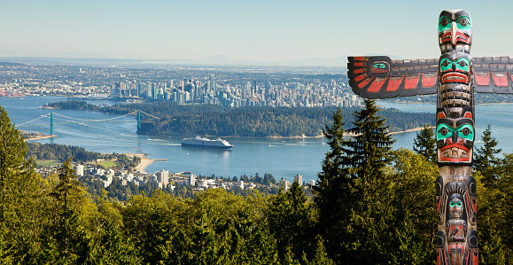 Vancouver as seen from viepoint  on the road to Cypress bowl. First nation totem pole in the front