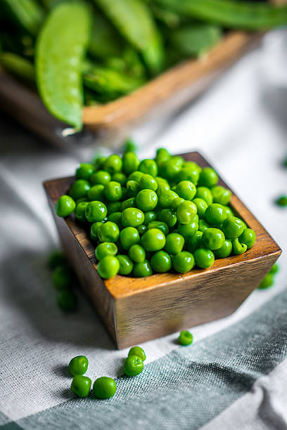 istock Peas on wooden background 526567956