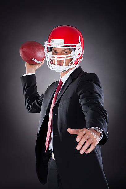 istock Businessman Holding Rugby Ball 526568841