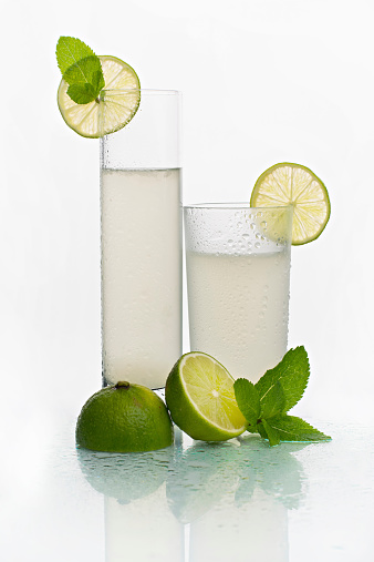 Two glasses with cold lemonade. Studio shot. White background