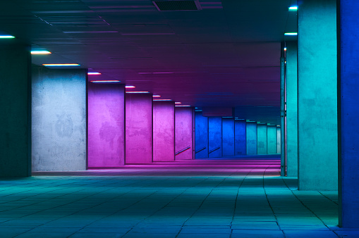 Great architecture & design of a walkway lit by different coloured lights