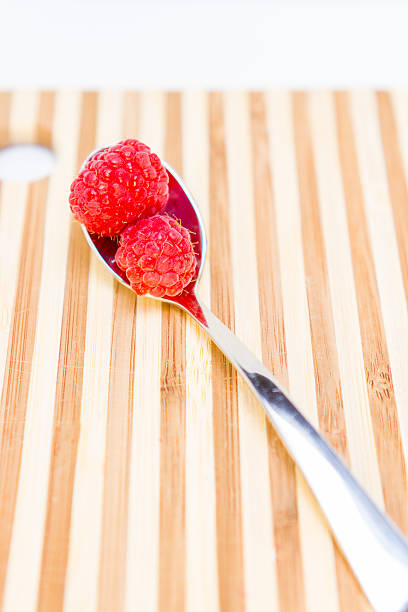 istock Spoonful of Raspberries 526572459