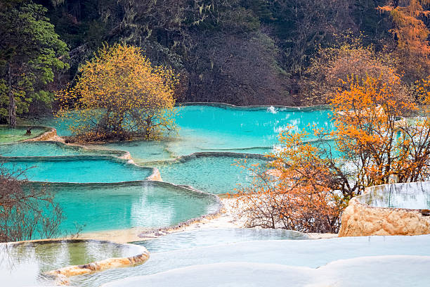 istock travertine landscape in autumn huanglong 526573659
