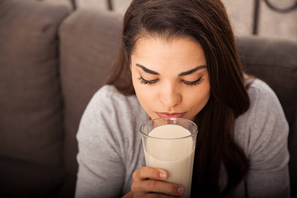 istock Pretty girl drinking milk 526574493