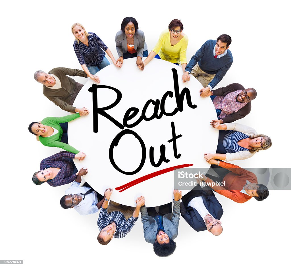 Group of People Holding Hands Around the Word Reach Out Aerial View Stock Photo