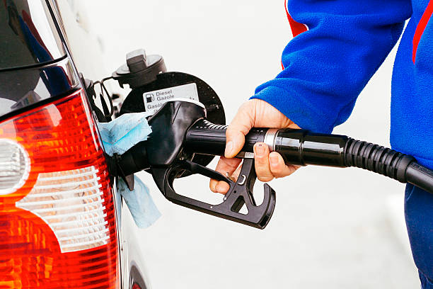 istock transportation and ownership concept - man pumping gasoline fuel 526594675