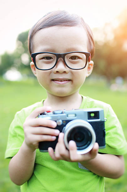 istock cute child plays the photographer 526594679