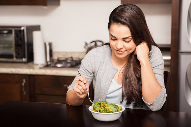 istock Eating a salad at home 526595029