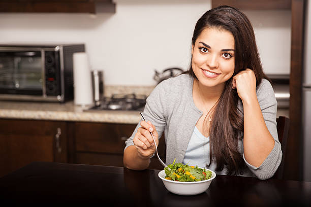 istock Happy girl eating a salad 526595037
