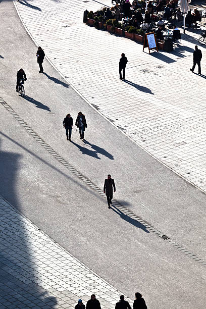 istock people walking at the street with long shadows 526595853