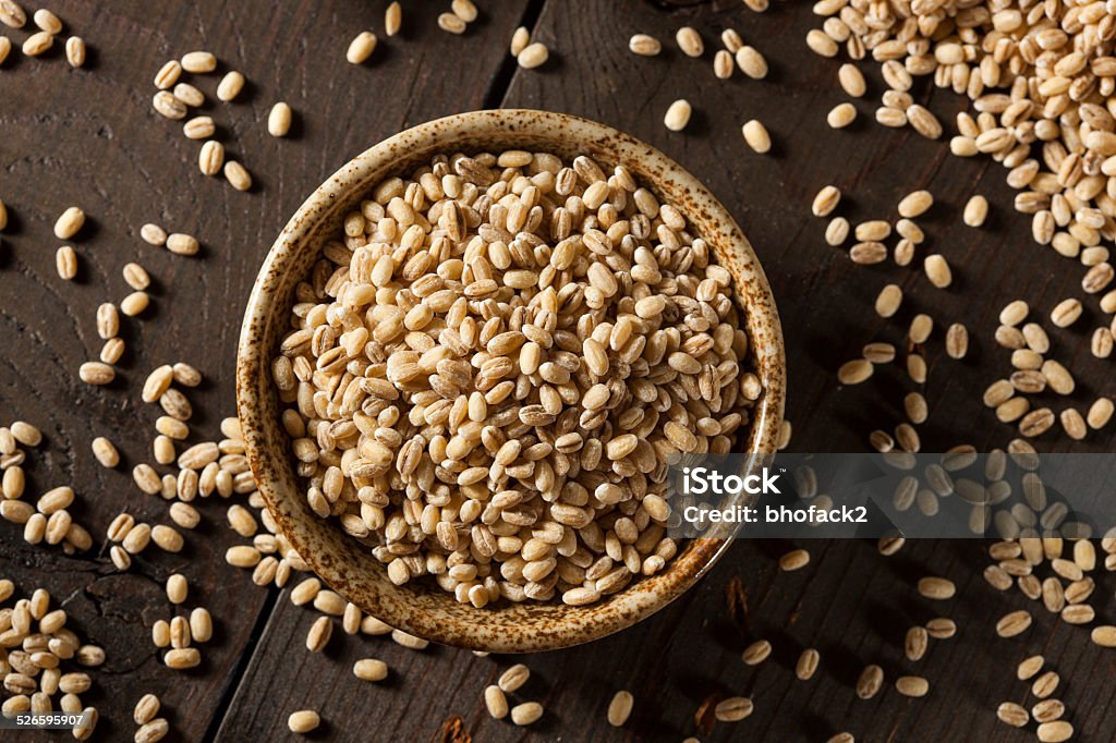 Raw Organic Barley Grain Raw Organic Barley Grain on a Background Agriculture Stock Photo