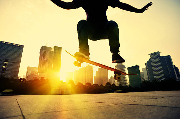 istock skateboarding woman jumping at  sunrise 526597087