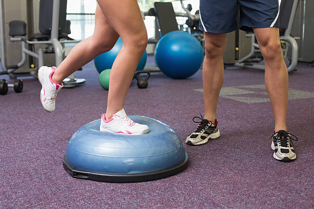 istock Low section of couple exercising at gym 526597609