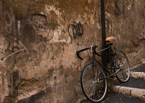 istock Rusty Bike Rests Against Ancient Grotty Wall, Rome 526598157