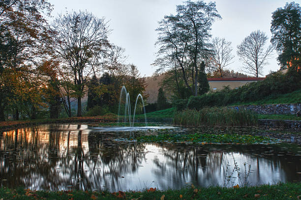 istock Autumn park and small lake at sunset 526598583