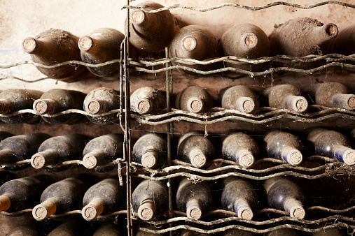 Aged bottles staying at wine cellar