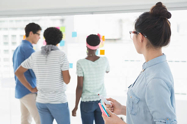 istock Young creative woman looking at team 526635853