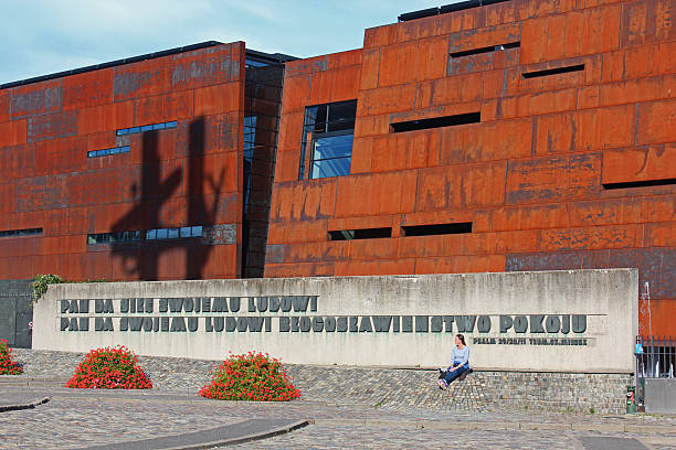 Poland, Gdańsk October 19th, 2014: Woman looking at monument to the Fallen Shipyard Workers Gdansk, Poland. Behind the European Solidarity Centre.